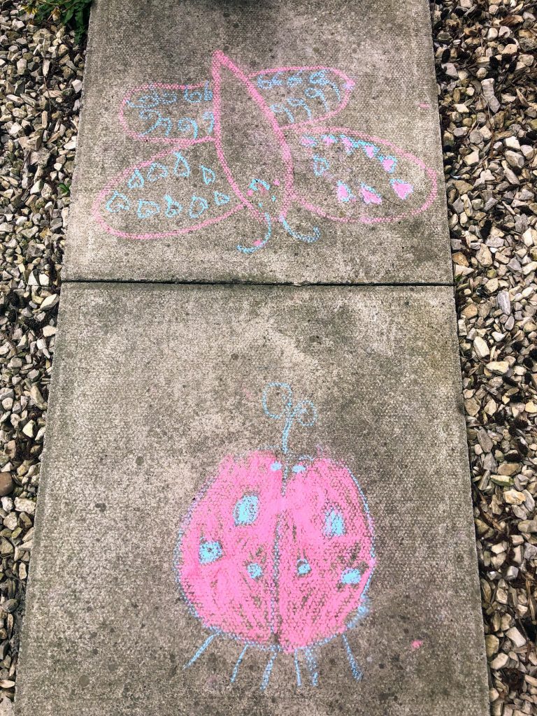 drawing with chalk on the sidewalk