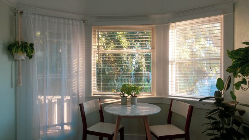 white wooden table with window blind lighting