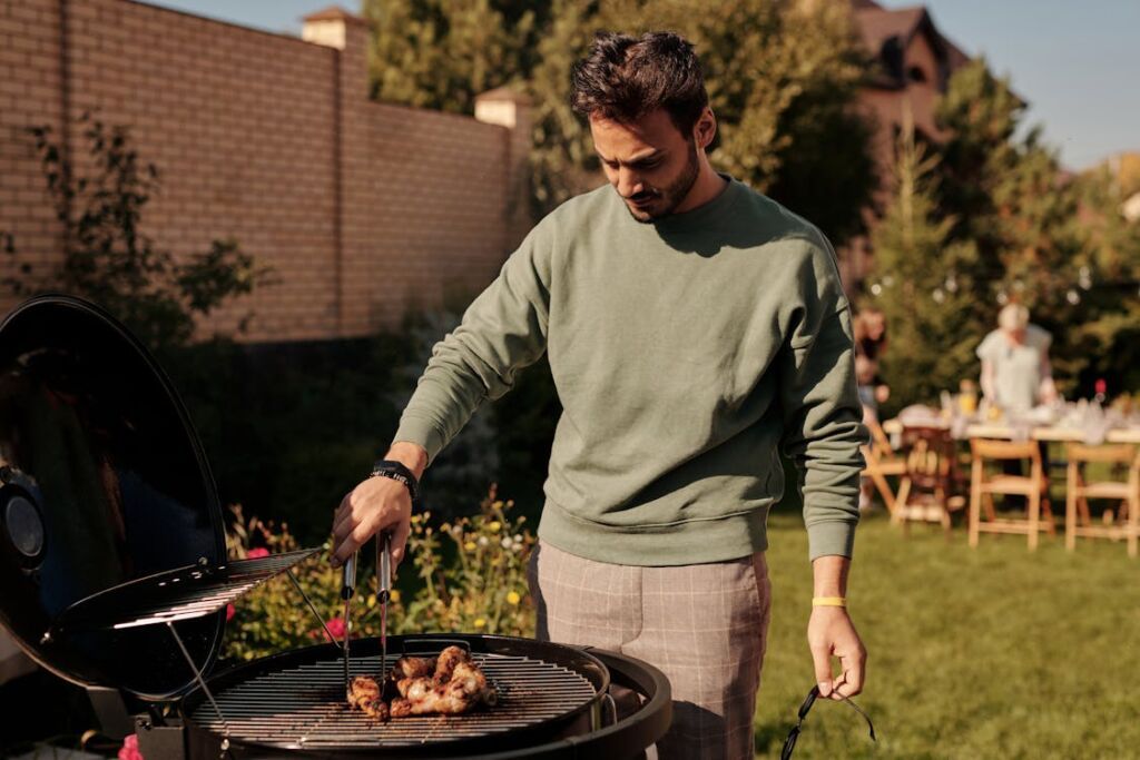 man enjoying cooking on a barbecue