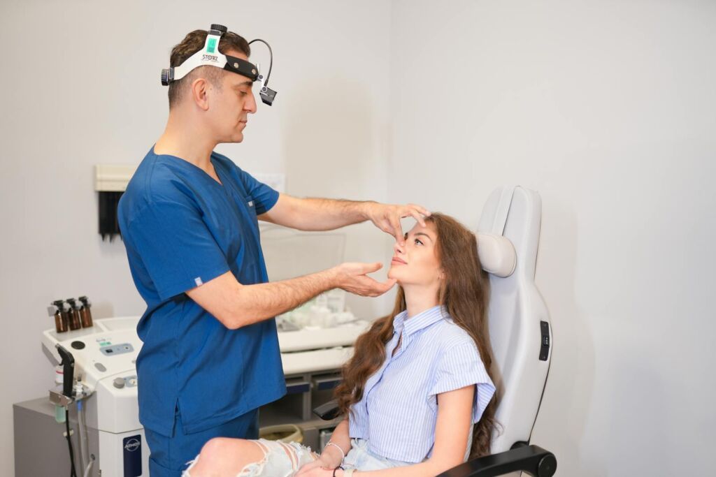 A plastic surgeon examines a patient's nasal structure in a modern clinic setting in Istanbul.