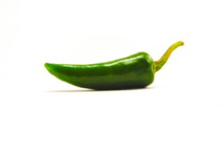 green chili on white surface