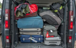 Van packed full with luggage for a trip.