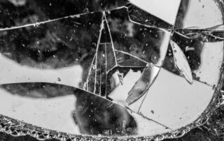 a broken mirror sitting on top of a sidewalk