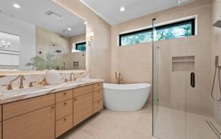 Modern bathroom with freestanding tub and double vanity.