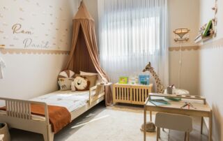 Cozy child's bedroom with bed and desk.