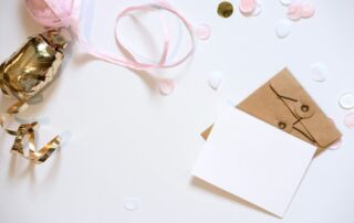 A blank card and envelope with festive decorations.