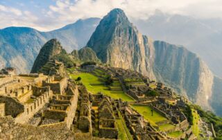 a large ancient city with Machu Picchu in the background