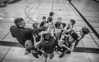 grayscale photography of boys raising hand