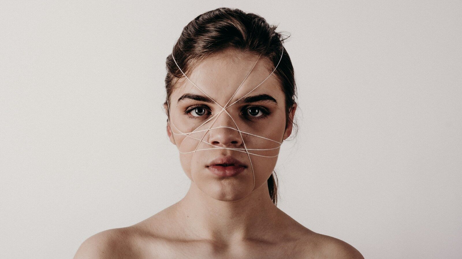 naked top woman with string with her face