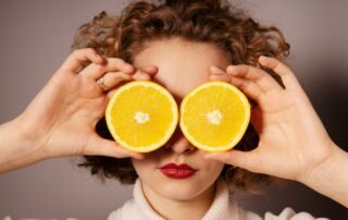 woman holding sliced orange fruit